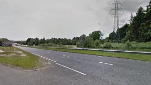 A Google Street View of a dual carriageway. Rows of trees are on one side.
