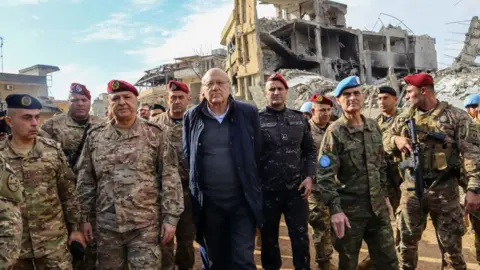 AFP Lebanon's caretaker Prime Minister Najib Mikati (C), Lebanese army commander, General Joseph Aoun (3rd Left), and Major General Aroldo Lazaro, Head of Mission and Force Commander of the United Nations Interim Force in Lebanon (UNIFIL) (2nd Right), visit the southern Lebanese village of Khiam on 23 December 2024