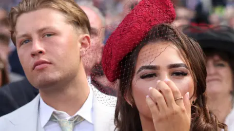 NEIL HALL/EPA/Shutterstock A couple attends the first day of Royal Ascot.