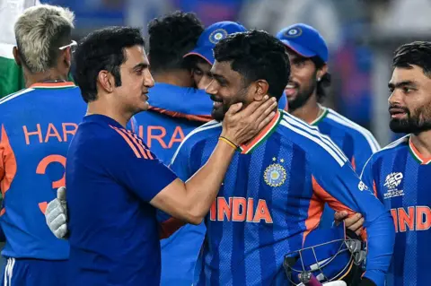 AFP via Getty Images India's Sanju Samson (C) celebrates with his coach Gautam Gambhir (L) after their team's win in the 2026 ICC Men's T20 Cricket World Cup final match against New Zealand at the Narendra Modi Stadium in Ahmedabad on March 8, 2026. (Photo by Punit PARANJPE / AFP via Getty Images)