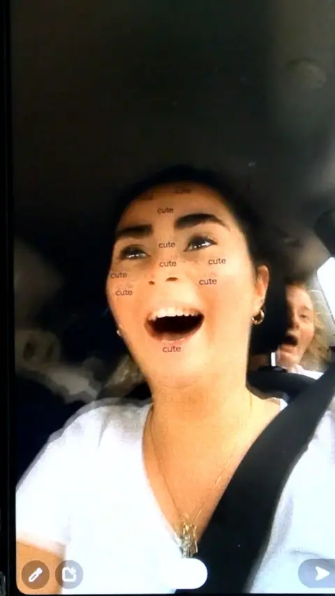 A woman filming herself driving