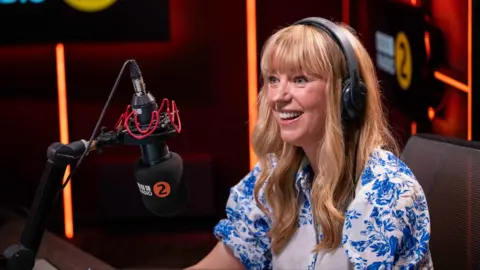 Sara Cox smiles.