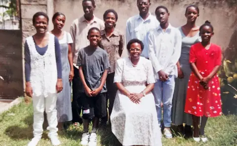 Dorothy Kweyu Dorothy Kweyu surrounded by her nine children in xxx