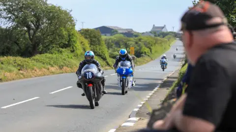 CALLUM STALEY A fan watching the the action from the side of the track as bikes approach.