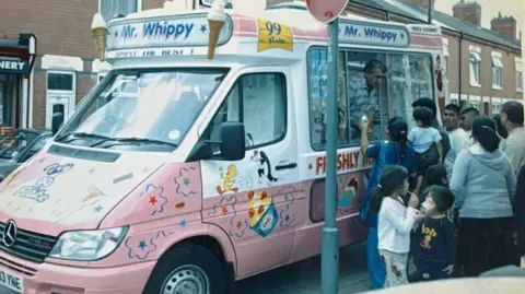 Supplied Dipak Davda serving customers ice-cream from his van in the 1980s.