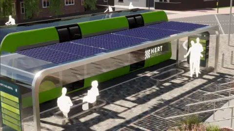 HERTFORDSHIRE COUNTY COUNCIL A mock artist impression of a tram stop with a shelter and a board with arrivals on one side. The words HERT are written on the side of the green tram which is parked by the stop.