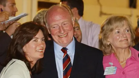 Alamy Neil Kinnock (centre) with Eluned Morgan (left) and his wife Glenys Kinnock (right) as they wait for the declaration at Haverfordwest