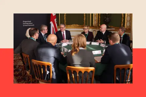 British Prime Minister Keir Starmer (C-L) hosts a round table at the Border Security Summit at Lancaster House
