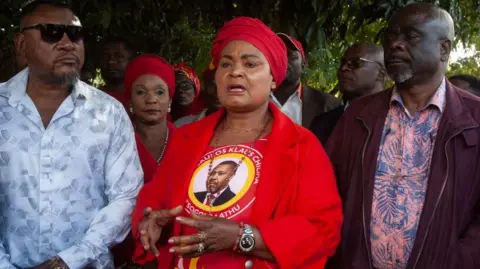 AFP Secretary General for Malawi's Vice President Saulos Klaus Chilima's UTM party, Patricia Kaliati (C), addresses supporters and sympathizers soon after a press briefing following a press briefing in Lilongwe, on June 11, 2024