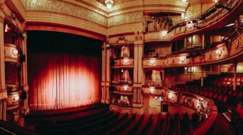 The seats and stage with curtains inside The Theatre Royal