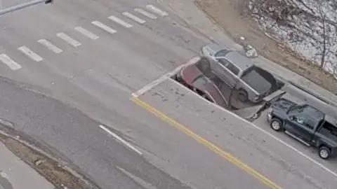 CCTV shows moment cars engulfed by sinkhole