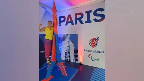 QUEEN VICTORIA HOSPITAL Kim Brinkworth standing in front of a Paris Paralymics GB display.
