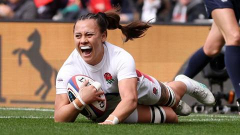 Maddie Feaunati scoring a try for England