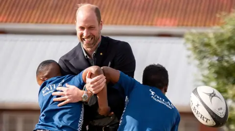 Prince William playing rugby with schoolhouse  children successful  Cape Town