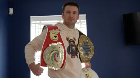 Artur Saladiak with his world title belts