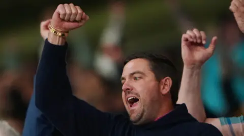 PA Chris Kirchner raises a clenched fist