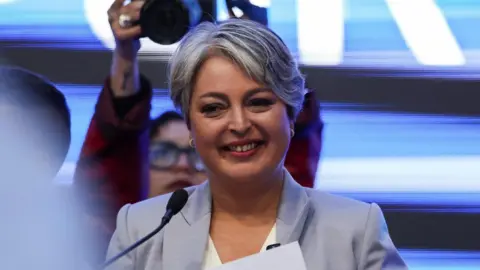 Reuters Jeannette Jara, presidential candidate of the ruling leftist coalition and member of the Communist Party, addresses supporters as she concedes defeat in the presidential runoff election, in Santiago, Chile.