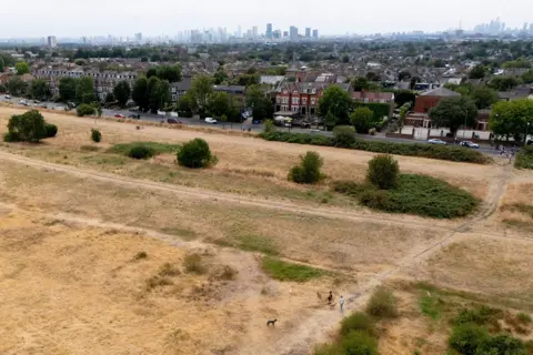 EPA An aerial view taken with a drone shows dry grass across Leyton Flats in east London, Britain, 22 July 2026.