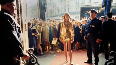 Alamy Francoise Hardy wears a gold dress