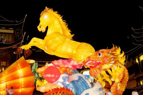 A yellow lantern in the shape of a horse