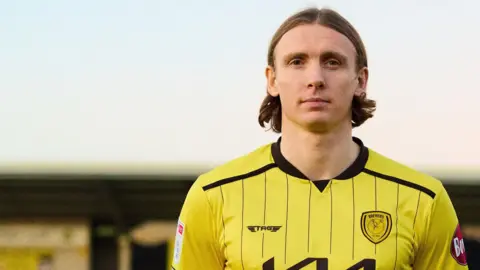 Jon Dadi Bodvarsson wearing his new Burton shirt after joining the League One club