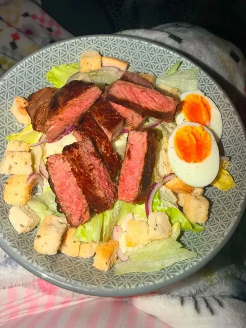 Aimee Ludgate A plate with sliced cook steak, boiled eggs, crutons and lettuce