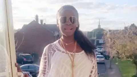 LinkedIn A woman in a white top with sunglasses smiles with a residential street visible behind her