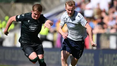 St Johnstone's Fran Franczak and Dundee's Scott Tiffoney in action