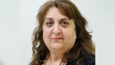 Slough Borough Council A professional headshot of a woman with curly brown hair and wearing light brown eye shadow, looking straight at the camera.