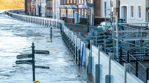 Getty Images Flood defences holding back water from houses