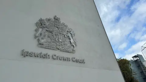 George King/BBC The Ipswich Crown Court logo on a concrete building