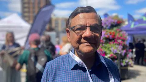 Jenny Kirk/BBC Kamal Acharya at a festival