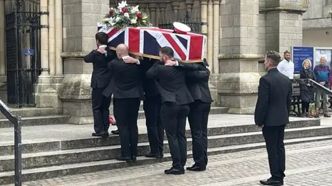 Jim Henderson's coffin goes into Truro Cathedral