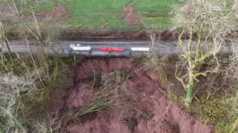 Drone shows the scale of the landslip in relation to the closed off road