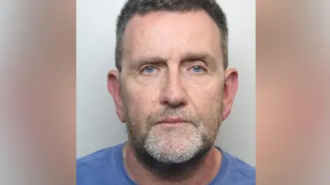 South Yorkshire Police A custody image of Kevin Proctor