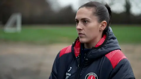 Katie Bradley talking to the camera on the pitch