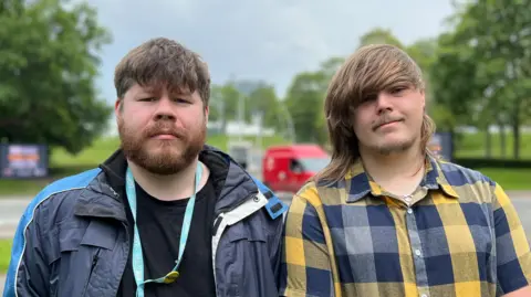 Two University of Derby students standing outside the main campus on Kedleston Road