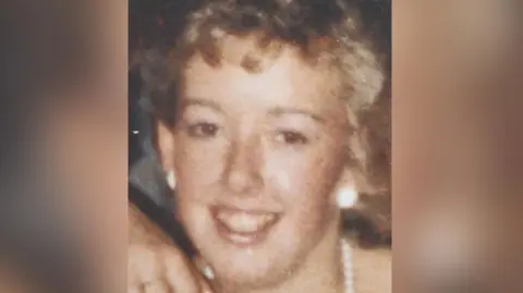 Merseyside Police handout Undated image of the late Diane Sindall, who has short blonde curly hair wearing matching white earrings and necklace. She is smiling at the camera.