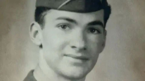 Andy Garner A black and white image of private first class Earl G Thurman of the US 82nd Airborne during World War Two. He is wearing a garrison cap. 