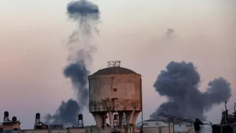 Reuters Smoke rises above and around a water tank in Khan Younis