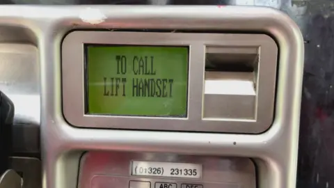 A close-up of an old BT payphone