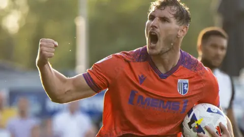 Josh Andrews celebrates scoring a goal for Gillingham