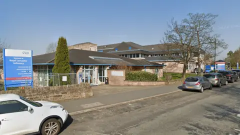 Google Lancaster General Infirmary. A stone building links directly with the road and is surrounded by a low wall.