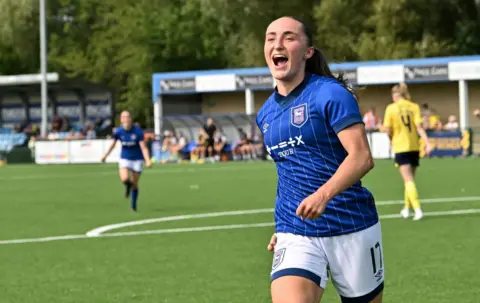 Ipswich Town FC Sophie Peskett wearing a blue kit and smiling