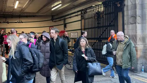 People walking down a driveway 