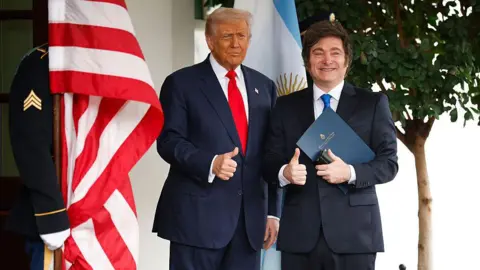 Getty Images US President Donald Trump (L) and President of Argentina Javier Milei make the thumbs up sign standing at the White House on October 14, 2025