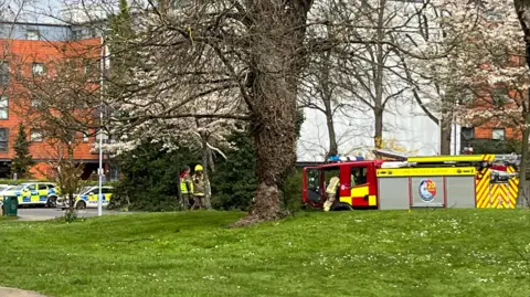Emergency service vehicles outside a building. 