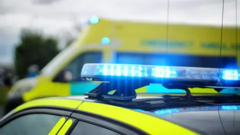 Library image of emergency vehicles with their blue lights flashing