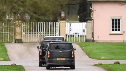 EPA/Shutterstock Vans driving up to the gates of Royal Lodge