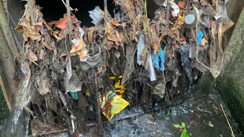 CURB Marnham Field outfall shows leaves and other waste trapped on a metal grille.